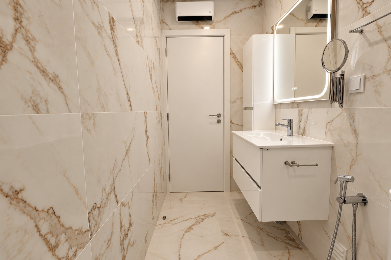 White door, vanity unit and light bathroom finishes with gold-toned veining