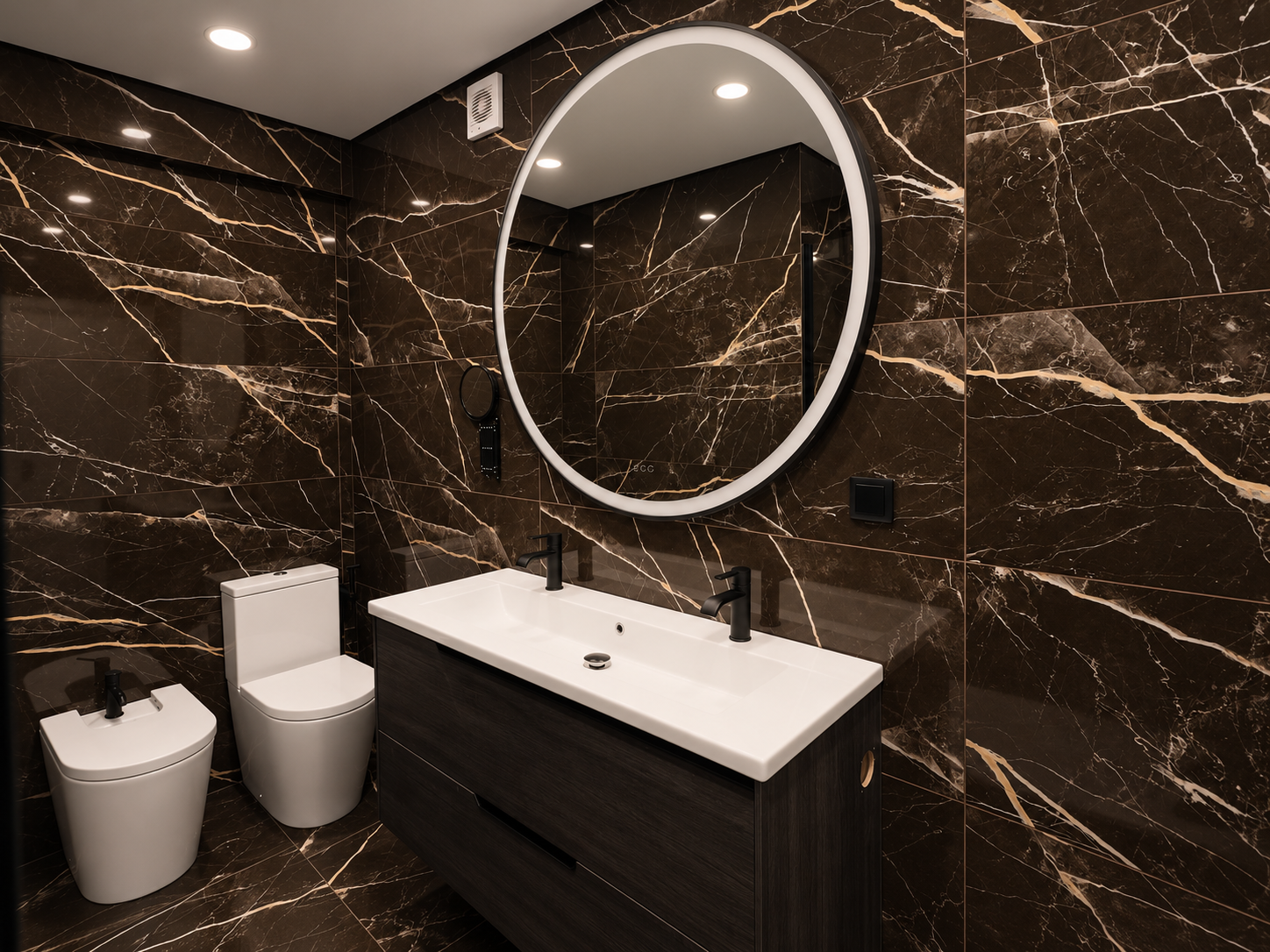White washbasin on a dark vanity, with a round mirror and white sanitaryware